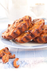 Sweet muffins with dried fruit on the white background