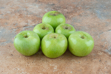 Green fresh sweet apples on marble background