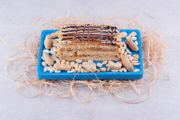 Homemade cake with peanuts on blue plate