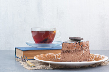 A piece of cake with aroma tea and book