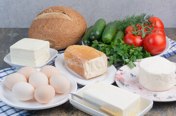 Dairy products, bread and vegetables for breakfast