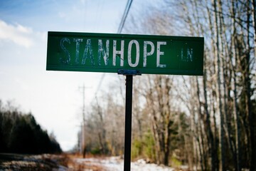 Closeup of a faded road sign of Stanhope Lane in Maine, USA during winter