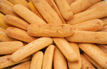 A plate full with sponge fingers biscuits used during an outdoor wedding ceremony.