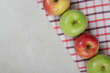 Colorful fresh apples on striped tablecloth
