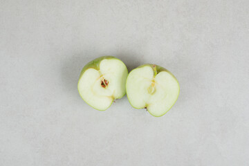 Half cut fresh apples on gray background