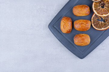 Homemade pastries with dried orange on dark plate