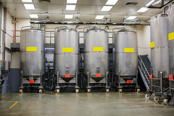 Stainless vertical steel tanks with pressure meter in equipment tank chemical cellar at the with...