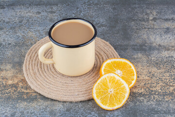 A cup of aroma coffee with slices of orange