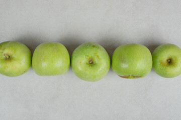 Whole green apples on gray background