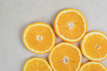 Fresh orange slices on gray background