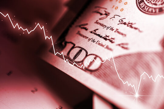 The concept of economic and financial crisis. Graphs down on the background of US dollar bills.