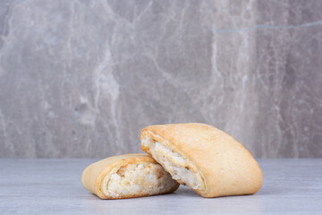 Cream filled biscuits on marble background