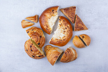 Half cut sweet pastries with cheese and raisins