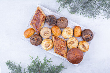 Assortment of tasty cookies on wooden board