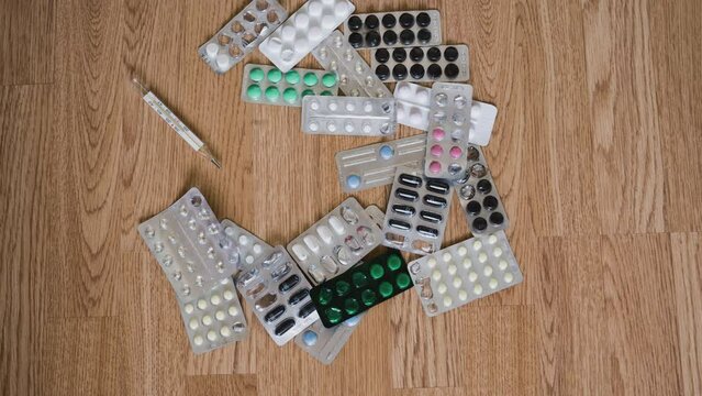 Stop motion packs of pills move in a column. Healthcare industry concept. Pharmaceutical, medical capsules are removed from the table. Components of medicines, capsules-tablets of a medical product.