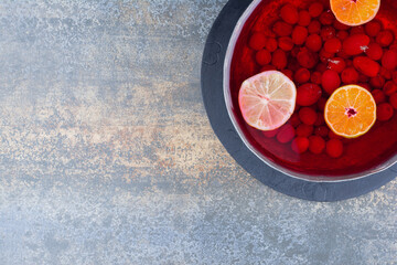 A dark pan of red juice on marble background