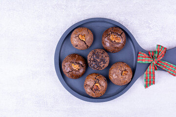 Chocolate cookies on dark board with ribbon
