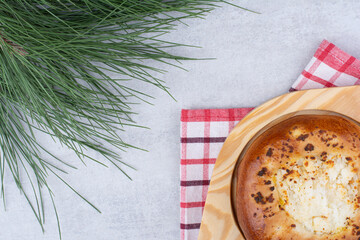 Cheese pastry on wooden plate with tablecloth