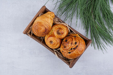 Various sweet pastries in wooden bowl