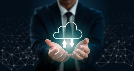 A businessman's hand grips a cloud. Close-up of a young businessman with a cloud over his palm, representing the cloud computing idea. The cloud service idea