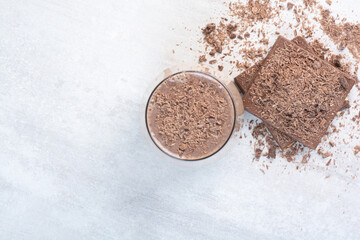 Cup of coffee and chocolate bar with cocoa powder