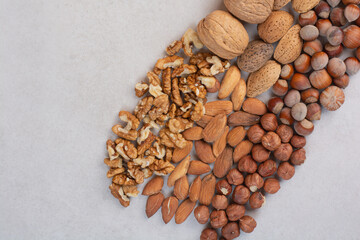 Mixed healthy nuts on marble background