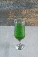 Delicious green fresh lemonade on marble background