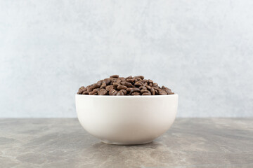 Bunch of coffee beans in white bowl