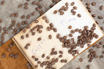 Bunch of coffee beans scattered on notebook