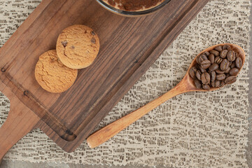 Biscuits on wooden board with coffee beans