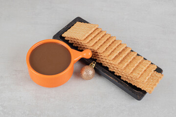 Cup of coffee and biscuits on marble background