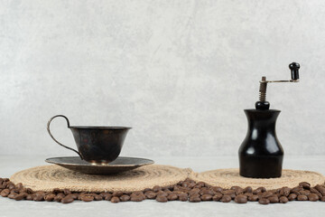 Coffee beans and coffee grinder on marble background