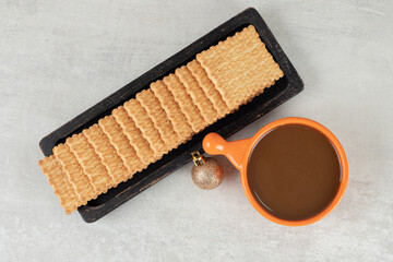 Cup of coffee and biscuits on marble background