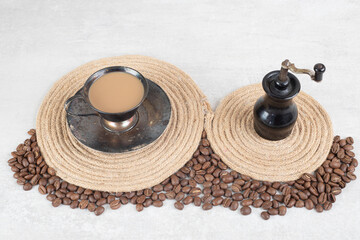 Fototapeta na wymiar Coffee beans and coffee grinder on marble background