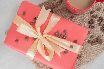 Red cup and coffee beans with gift box
