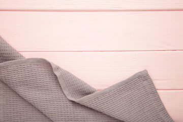 The checkered tablecloth on pink background. Decorative cotton napkin.