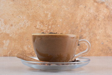 A cup of aroma tasty coffee with cinnamon sticks and star anise