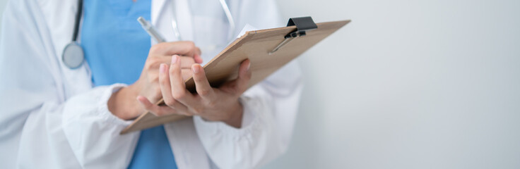 Hand of doctor holding patient clipboard with copy space for adding text or advertising. Medical healthcare career
