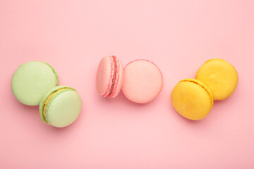 French colorful macarons on pink background