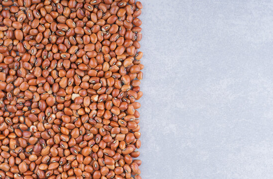 Heap of red bean tidily arranged on marble background