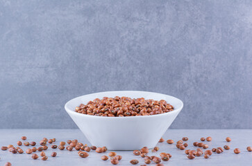 Bowl of red beans on marble background