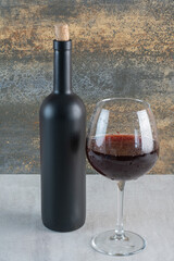 A glass of wine with bottle on white background