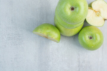 Bunch of green apples on stone background