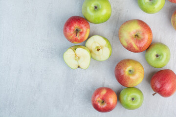 Bunch of red and green apples on stone table