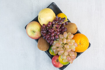Fruit plate with grapes, citrus fruits and kiwi