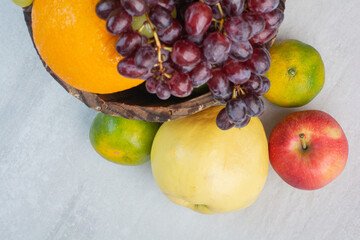 Bunch of various fruits in wooden bucket