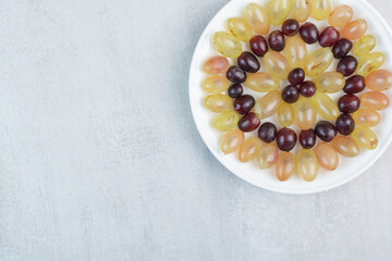 Fresh grapes plate on stone background