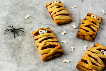 Shortbread cookies with jam for Halloween. Top view of cookies, decor spider. On a gray background,...