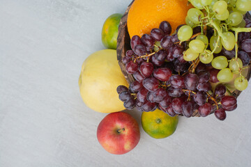 Bunch of various fruits in wooden bucket