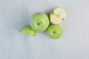 Bunch of green apples on stone background